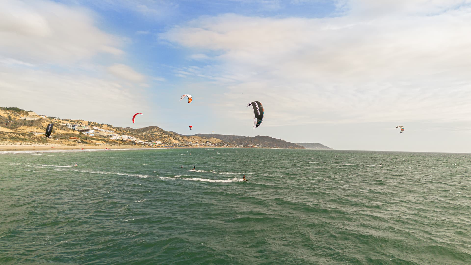 Kitesurfers riding off Playa Santa Marianita with their kites in the air